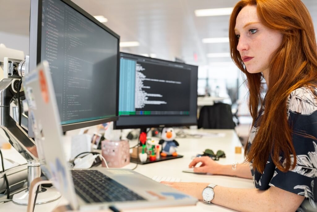 A woman in an office researching telecom expense management during a meeting
